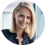Professional woman smiling in a business setting, representing client satisfaction with Cactus Home Offer's home-selling services.