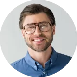 Smiling man with glasses in a blue shirt, representing client satisfaction with Cactus Home Offer's hassle-free home selling services.